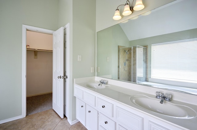 13012 Balsam Breeze Ln, Pearland, TX 77584 - full bath with a stall shower, tile patterned flooring, double vanity, a spacious closet, and vaulted ceiling