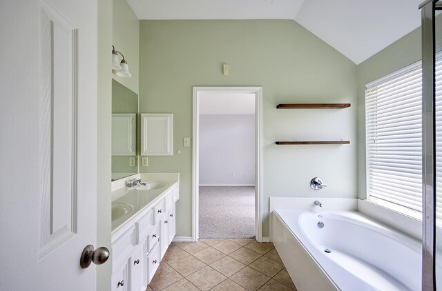 13012 Balsam Breeze Ln, Pearland, TX 77584 - full bath featuring double vanity, vaulted ceiling, a bath, tile patterned floors, and baseboards