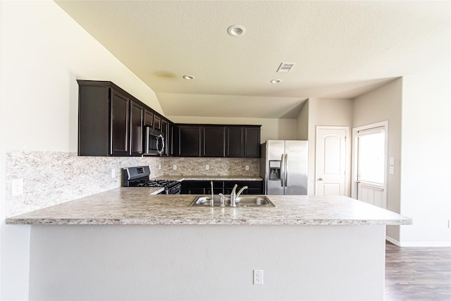 20910 Corisande St, Katy, TX 77449 - kitchen with stainless steel appliances, a sink, backsplash, a peninsula, and light countertops