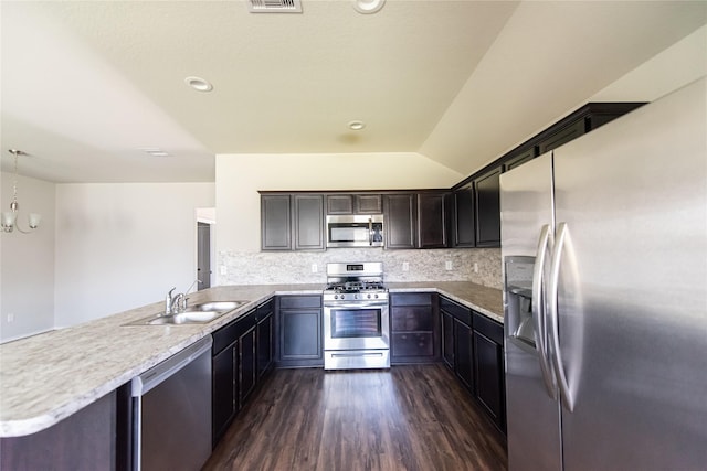 20910 Corisande St, Katy, TX 77449 - kitchen with stainless steel appliances, a peninsula, a sink, dark wood-style flooring, and light countertops