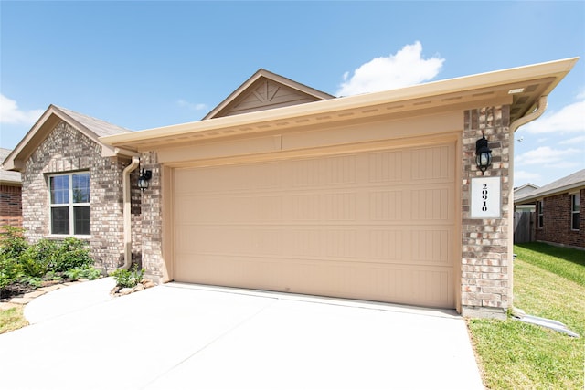 20910 Corisande St, Katy, TX 77449 - ranch-style house featuring concrete driveway, an attached garage, and brick siding