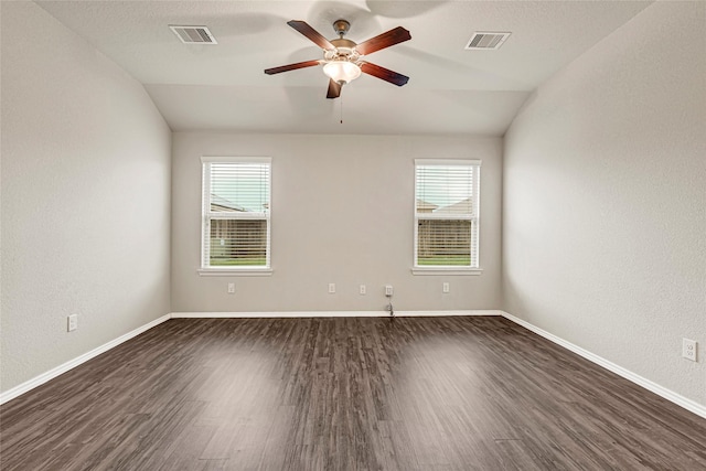 20910 Corisande St, Katy, TX 77449 - empty room with dark wood-style floors, vaulted ceiling, healthy amount of natural light, a ceiling fan, and a textured wall