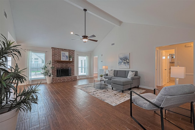 6526 Mert St, Katy, TX 77493 - living area featuring high vaulted ceiling, ceiling fan, dark wood finished floors, a brick fireplace, and beam ceiling