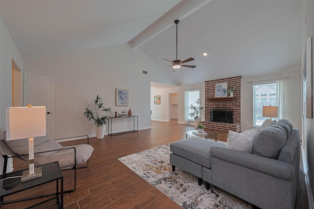 6526 Mert St, Katy, TX 77493 - living area featuring beamed ceiling, a ceiling fan, a brick fireplace, dark wood finished floors, and high vaulted ceiling