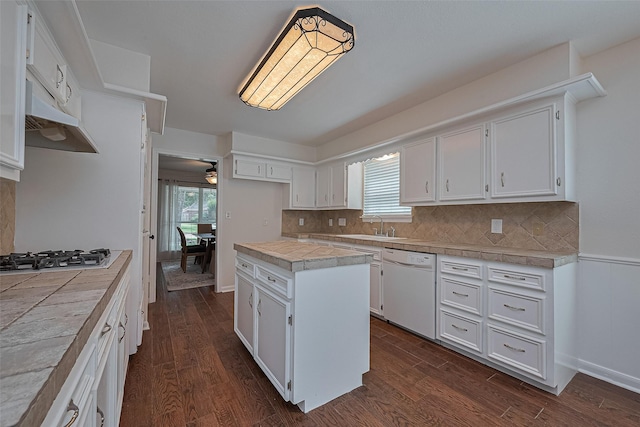 6526 Mert St, Katy, TX 77493 - kitchen with dishwasher, stainless steel gas cooktop, white cabinetry, a center island, and decorative backsplash