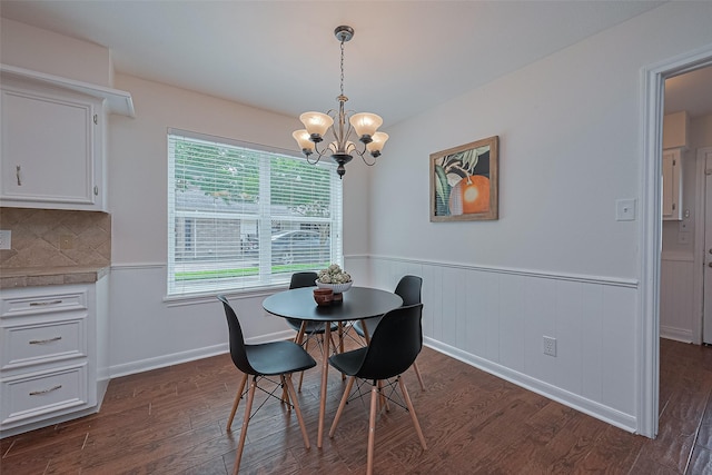6526 Mert St, Katy, TX 77493 - dining area featuring a chandelier, dark wood-type flooring, plenty of natural light, and wainscoting