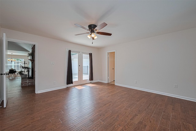 6526 Mert St, Katy, TX 77493 - spare room with a ceiling fan, dark wood-style floors, french doors, a chandelier, and baseboards