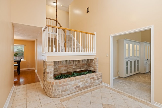 12910 Lake Mist Dr, Cypress, TX 77429 - stairway featuring a towering ceiling, baseboards, and tile patterned floors