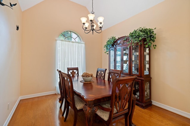 12910 Lake Mist Dr, Cypress, TX 77429 - dining area with a chandelier, light wood-style floors, lofted ceiling, and baseboards