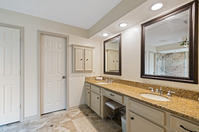 12910 Lake Mist Dr, Cypress, TX 77429 - bathroom featuring double vanity, tiled shower, baseboards, and recessed lighting