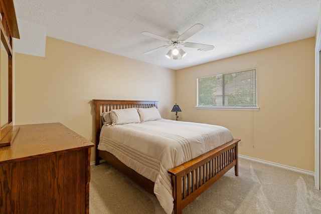 12910 Lake Mist Dr, Cypress, TX 77429 - bedroom with light colored carpet, baseboards, ceiling fan, and a textured ceiling