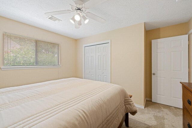 12910 Lake Mist Dr, Cypress, TX 77429 - bedroom with light colored carpet, a closet, ceiling fan, a textured ceiling, and baseboards
