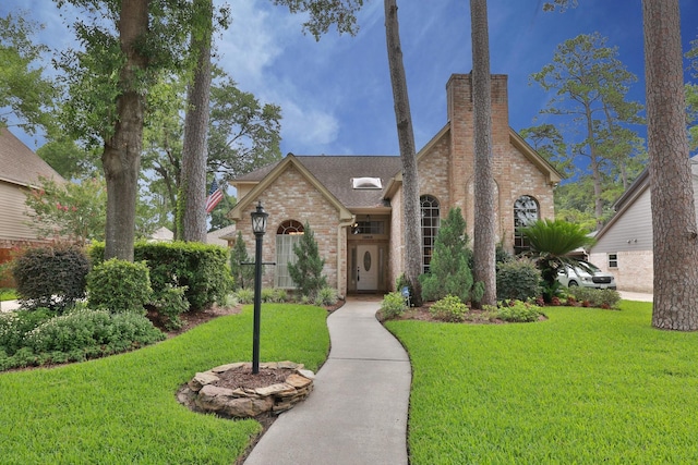 12910 Lake Mist Dr, Cypress, TX 77429 - view of front of home with a front lawn, brick siding, a chimney, and roof with shingles