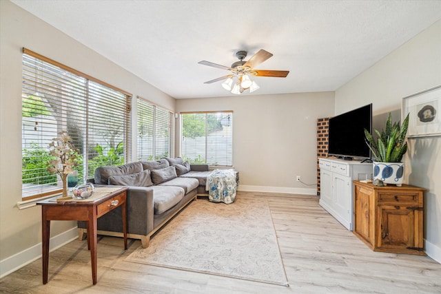 18614 Atasca Oaks Dr, Humble, TX 77346 - living room with a ceiling fan, light wood-type flooring, and baseboards