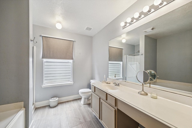 18614 Atasca Oaks Dr, Humble, TX 77346 - full bathroom with a shower stall, vanity, baseboards, toilet, and a bath