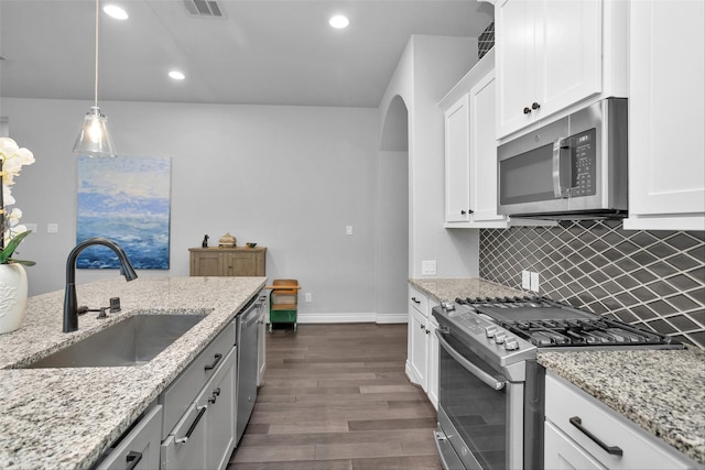 20423 Noble Arabian Dr, Tomball, TX 77377 - kitchen with stainless steel appliances, dark wood-style floors, recessed lighting, decorative backsplash, and white cabinetry