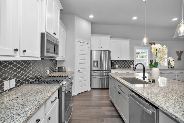 20423 Noble Arabian Dr, Tomball, TX 77377 - kitchen featuring stainless steel appliances, dark wood-style floors, white cabinetry, tasteful backsplash, and recessed lighting