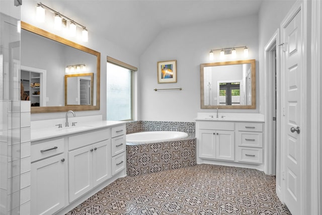 20423 Noble Arabian Dr, Tomball, TX 77377 - full bath featuring two vanities, a closet, vaulted ceiling, a garden tub, and tile patterned flooring