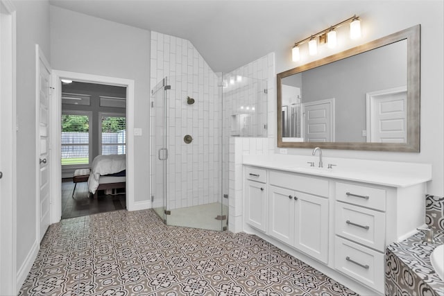 20423 Noble Arabian Dr, Tomball, TX 77377 - bathroom with vaulted ceiling, vanity, a stall shower, connected bathroom, and tile patterned flooring