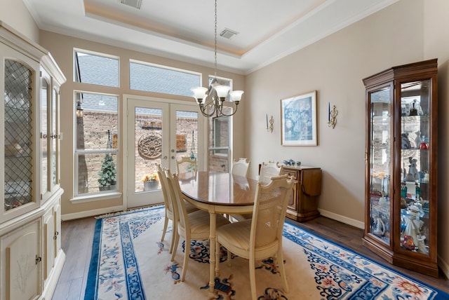 25514 Long Iron Ct, Spring, TX 77389 - dining room featuring a chandelier, a raised ceiling, light wood finished floors, french doors, and crown molding