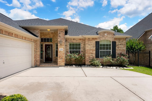 25514 Long Iron Ct, Spring, TX 77389 - view of front of property with brick siding, roof with shingles, concrete driveway, and an attached garage