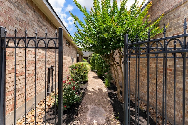 25514 Long Iron Ct, Spring, TX 77389 - view of property exterior with brick siding and a gate