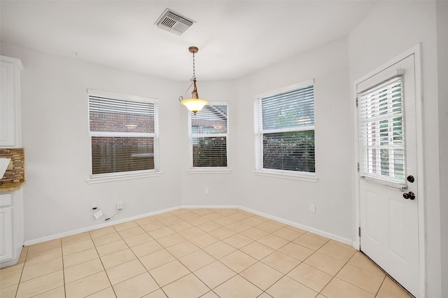 3606 Mira Glen Dr, Pearland, TX 77584 - unfurnished dining area featuring light tile patterned floors and baseboards
