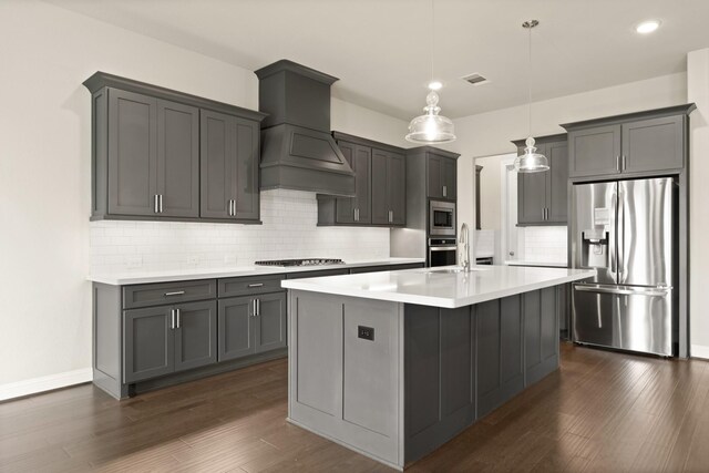 27423 Parker Spring Ct, Katy, TX 77494 - kitchen featuring stainless steel appliances, premium range hood, light countertops, backsplash, and dark wood-style floors