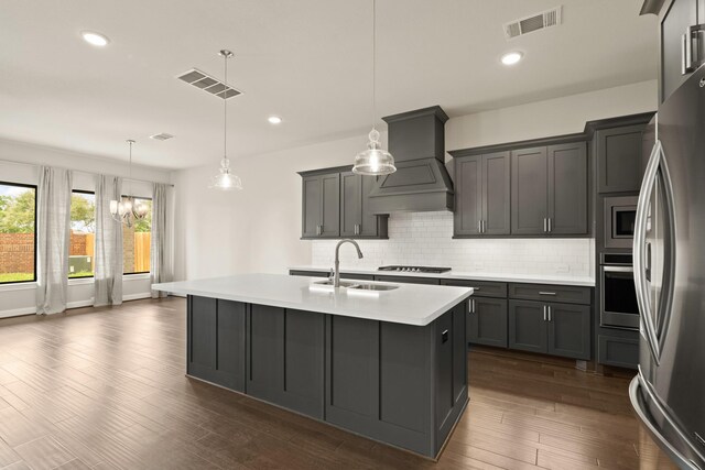 27423 Parker Spring Ct, Katy, TX 77494 - kitchen with a sink, appliances with stainless steel finishes, custom exhaust hood, decorative backsplash, and light countertops