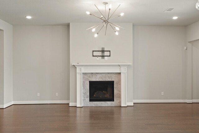 27423 Parker Spring Ct, Katy, TX 77494 - unfurnished living room featuring wood finished floors, a chandelier, baseboards, a tiled fireplace, and recessed lighting
