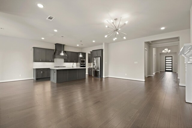27423 Parker Spring Ct, Katy, TX 77494 - unfurnished living room featuring a chandelier, a sink, baseboards, recessed lighting, and dark wood-type flooring