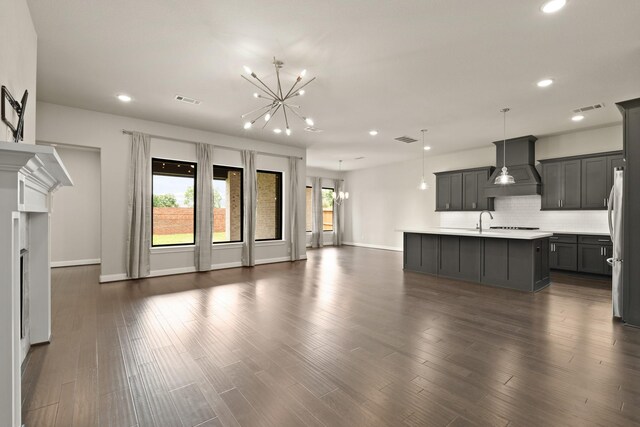 27423 Parker Spring Ct, Katy, TX 77494 - unfurnished living room featuring recessed lighting, a chandelier, baseboards, a sink, and dark wood-style flooring