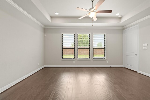 27423 Parker Spring Ct, Katy, TX 77494 - spare room with a raised ceiling, a ceiling fan, dark wood-type flooring, crown molding, and baseboards