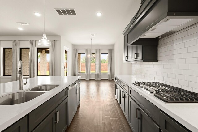 27423 Parker Spring Ct, Katy, TX 77494 - kitchen with stainless steel appliances, custom range hood, a sink, light countertops, and recessed lighting
