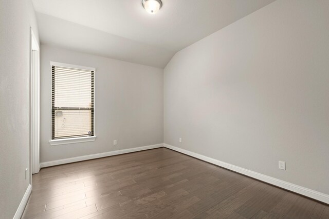 27423 Parker Spring Ct, Katy, TX 77494 - empty room with vaulted ceiling, wood finished floors, and baseboards