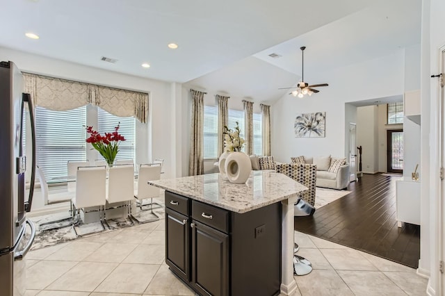 19251 N Cottonwood Green Ln, Cypress, TX 77433 - kitchen with stainless steel refrigerator, healthy amount of natural light, light tile patterned flooring, a ceiling fan, and lofted ceiling