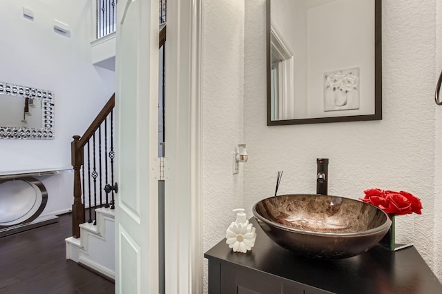 19251 N Cottonwood Green Ln, Cypress, TX 77433 - bathroom with a textured wall, wood finished floors, and vanity