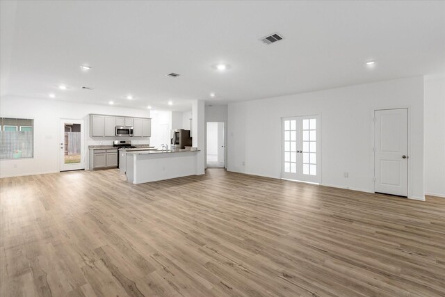 21219 Mangrove Ln, Cypress, TX 77433 - unfurnished living room with light wood-type flooring, recessed lighting, and baseboards