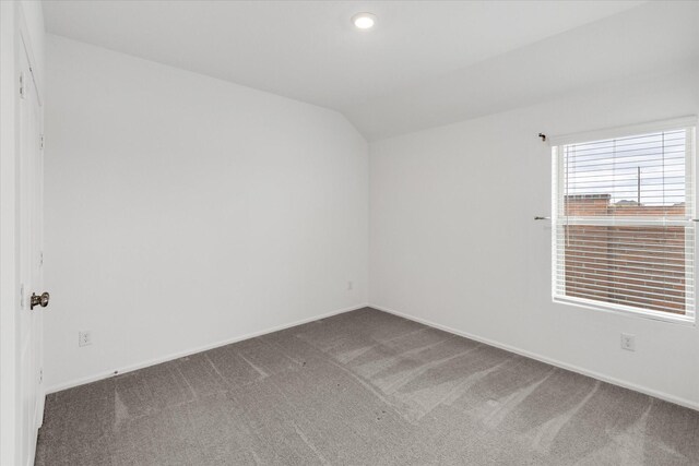 21219 Mangrove Ln, Cypress, TX 77433 - carpeted empty room featuring vaulted ceiling, baseboards, and recessed lighting