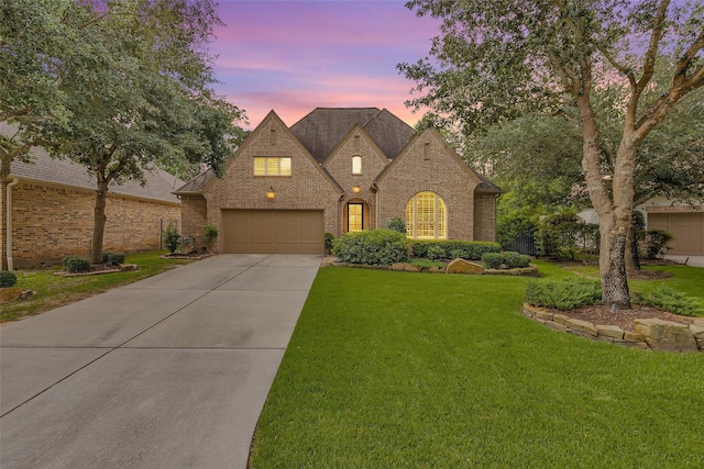 7 Woodglade Way, Tomball, TX 77375 - french country home with brick siding, concrete driveway, and a lawn