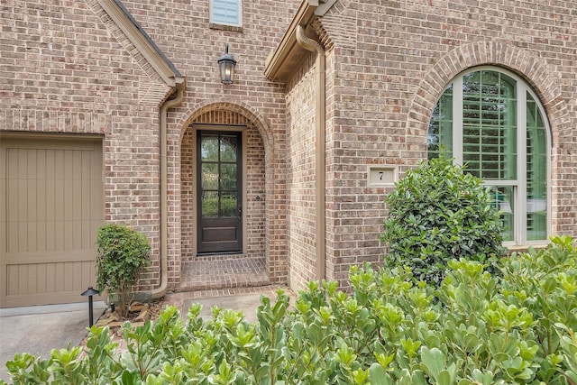 7 Woodglade Way, Tomball, TX 77375 - doorway to property with brick siding and a garage