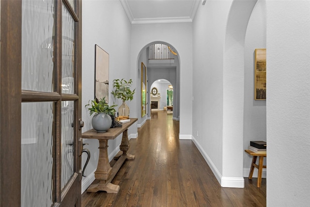 7 Woodglade Way, Tomball, TX 77375 - hall featuring arched walkways, wood finished floors, crown molding, baseboards, and a high ceiling