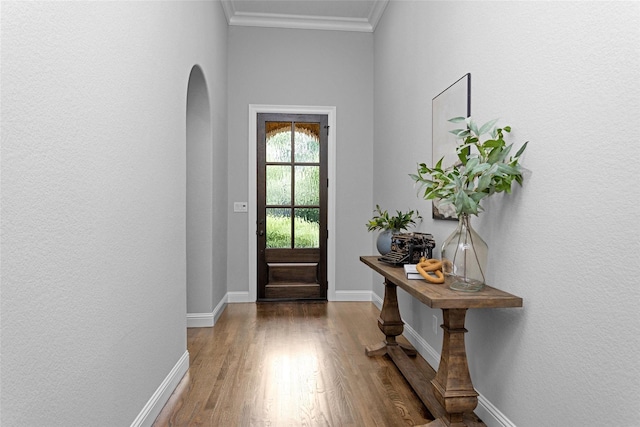 7 Woodglade Way, Tomball, TX 77375 - doorway with arched walkways, wood finished floors, ornamental molding, and baseboards
