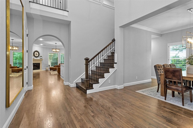 7 Woodglade Way, Tomball, TX 77375 - foyer entrance with a chandelier, plenty of natural light, wood finished floors, crown molding, and stairway