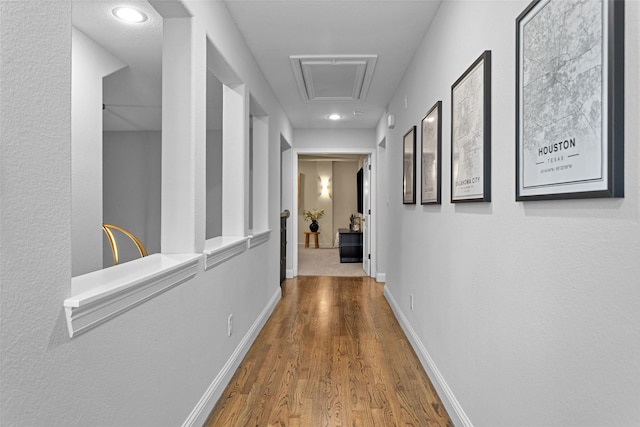 7 Woodglade Way, Tomball, TX 77375 - hallway with wood finished floors, baseboards, attic access, and recessed lighting