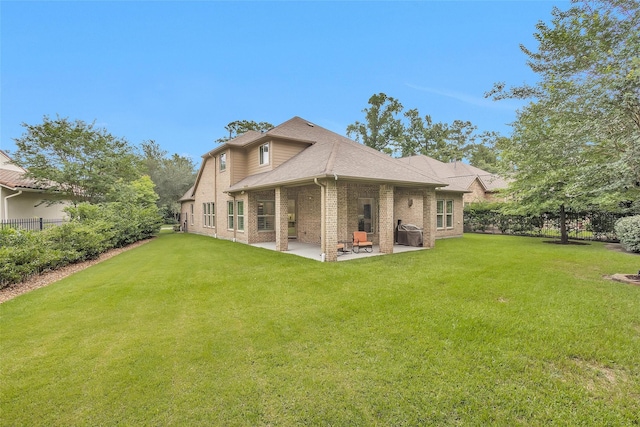 7 Woodglade Way, Tomball, TX 77375 - back of property with brick siding, a patio area, and roof with shingles
