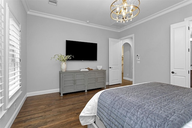 7 Woodglade Way, Tomball, TX 77375 - bedroom with arched walkways, wood finished floors, crown molding, baseboards, and a chandelier