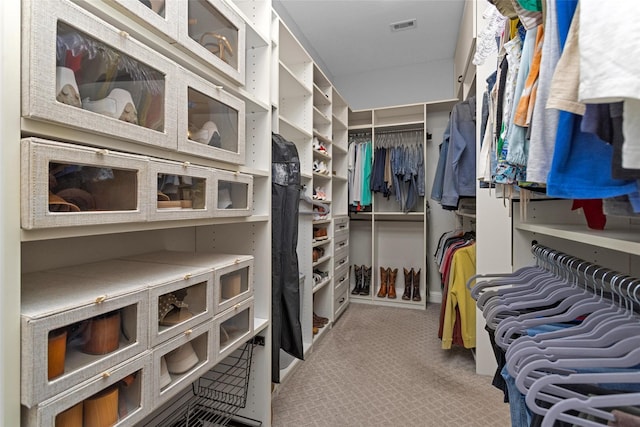 7 Woodglade Way, Tomball, TX 77375 - walk in closet featuring light colored carpet