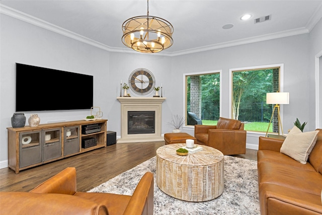 7 Woodglade Way, Tomball, TX 77375 - living area with a chandelier, a glass covered fireplace, crown molding, wood finished floors, and recessed lighting