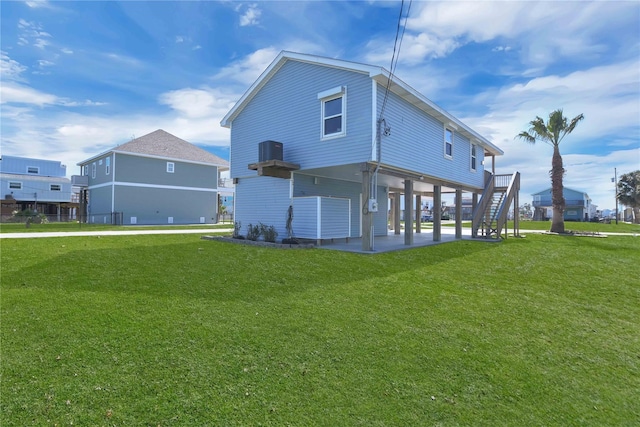 4023 Grayson Dr, Galveston, TX 77554 - back of house with a yard, stairway, and a patio